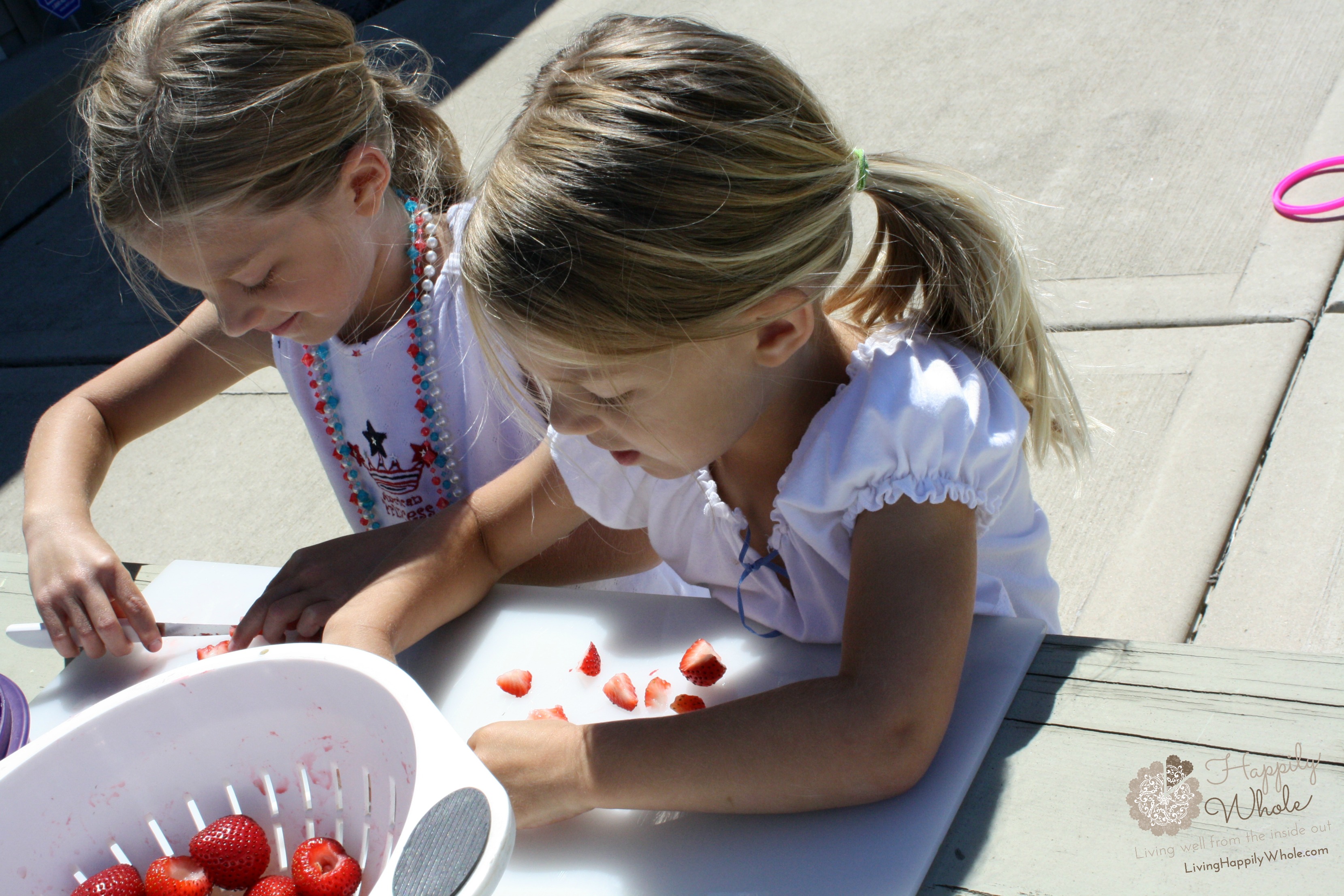 Girls chopping strawberries